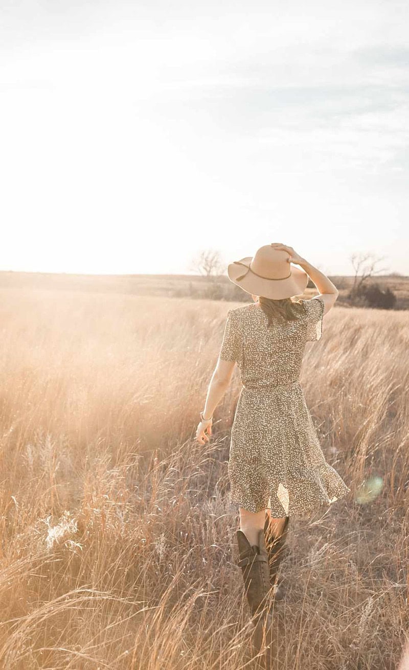 woman with hatwalking into horizon